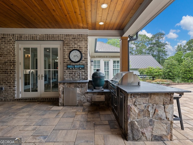 view of patio with grilling area, exterior kitchen, and french doors