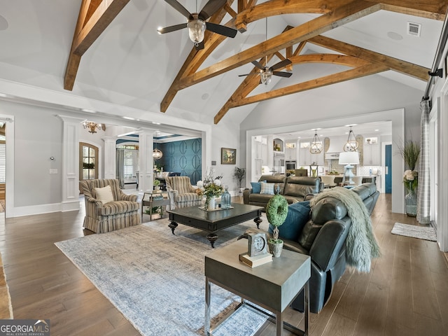 living room with dark hardwood / wood-style flooring, ceiling fan, high vaulted ceiling, beamed ceiling, and ornate columns