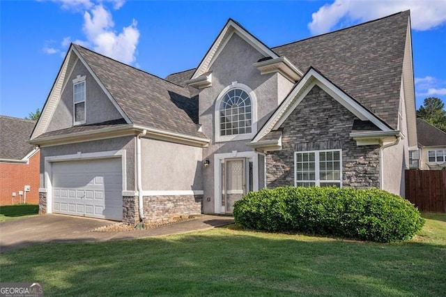 view of front of house with a garage and a front lawn