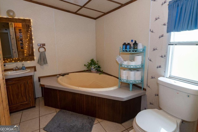 bathroom with a tub, vanity, toilet, and tile floors