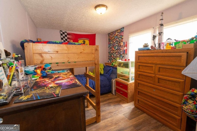 bedroom featuring a textured ceiling and wood-type flooring