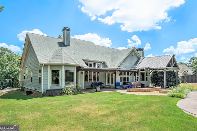 rear view of property with a yard and a patio area