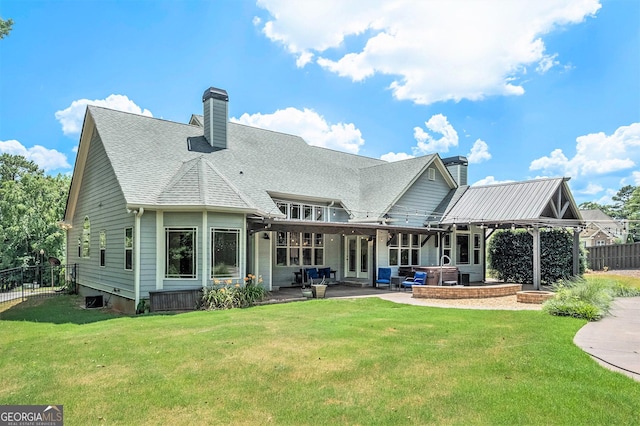 rear view of property with a patio area, a hot tub, a chimney, and fence