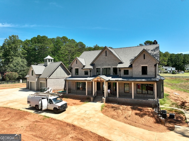 rear view of house featuring covered porch