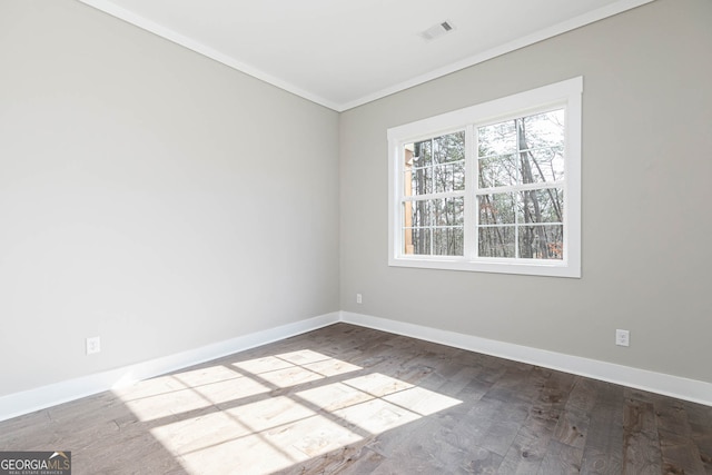 unfurnished room with a healthy amount of sunlight, wood-type flooring, and crown molding