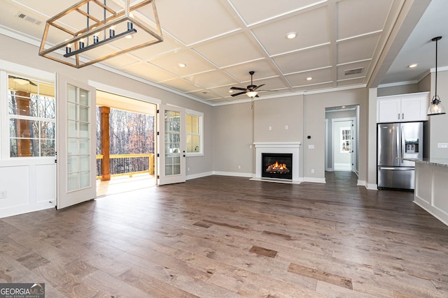 unfurnished living room with dark wood-type flooring, coffered ceiling, ceiling fan, and french doors