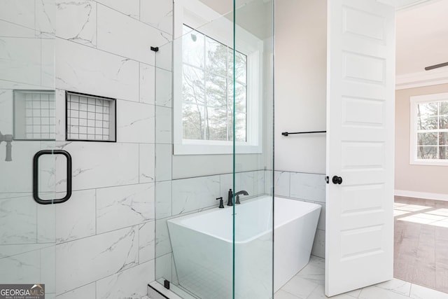 bathroom featuring tile walls, tile floors, crown molding, and shower with separate bathtub