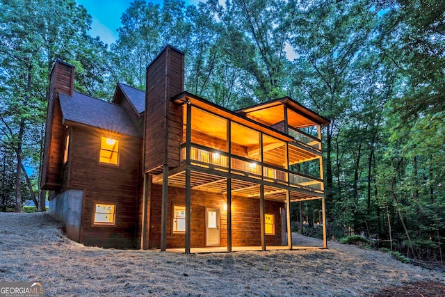 back of property with a balcony