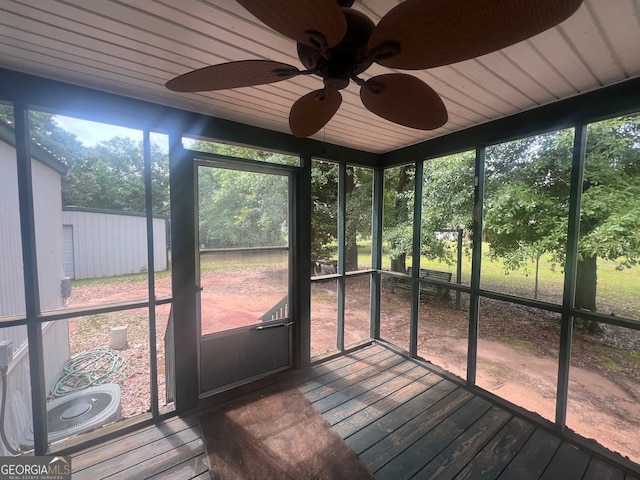 unfurnished sunroom with ceiling fan