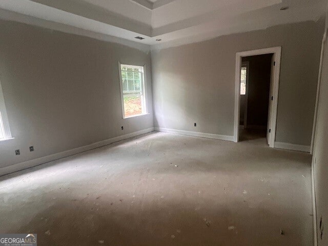 empty room featuring a tray ceiling