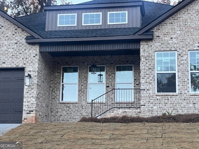 entrance to property with a lawn