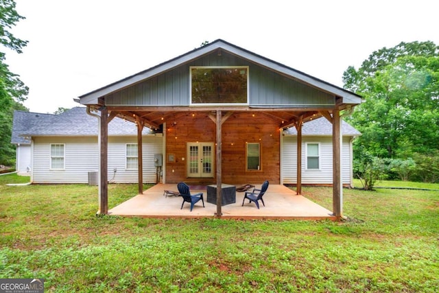 back of property featuring a patio area, a yard, and french doors