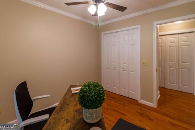 office featuring ceiling fan, wood-type flooring, and ornamental molding