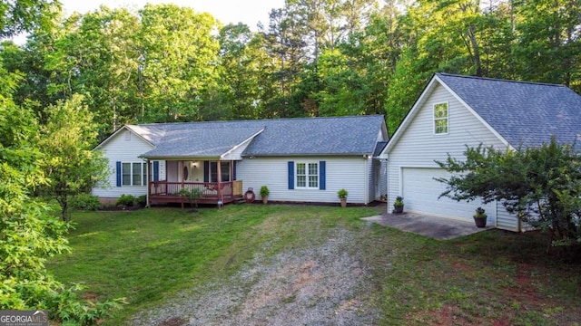 view of front of home featuring a porch, a garage, and a front lawn