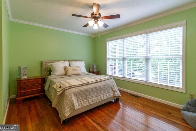 bedroom with ceiling fan, dark wood-type flooring, a textured ceiling, and ornamental molding