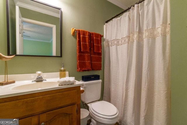 bathroom with walk in shower, toilet, vanity, and ornamental molding