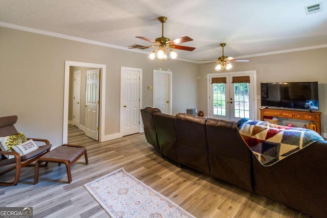 living room with french doors, light hardwood / wood-style flooring, ceiling fan, and crown molding