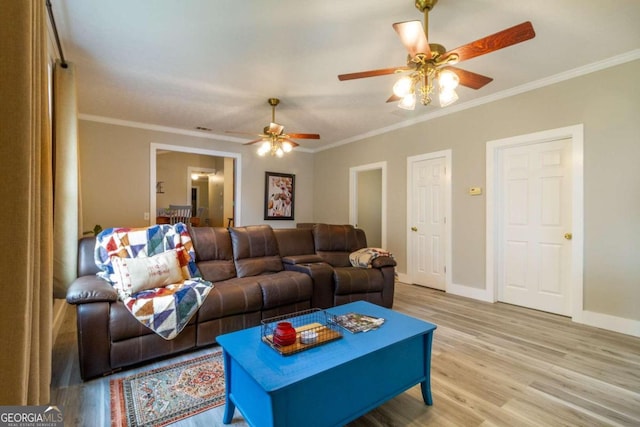 living room with crown molding, light hardwood / wood-style flooring, and ceiling fan