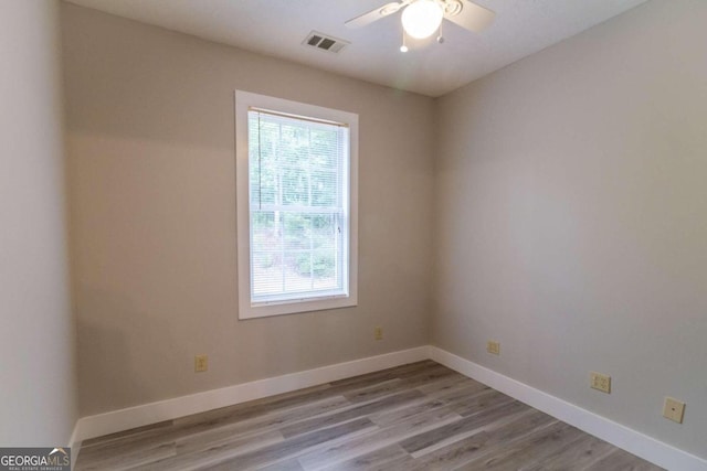 spare room featuring light hardwood / wood-style flooring and ceiling fan