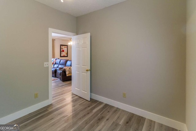 spare room with wood-type flooring and ceiling fan