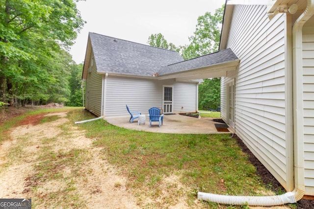 back of house with a lawn and a patio area