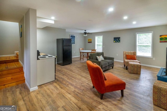 living room featuring light hardwood / wood-style floors, plenty of natural light, and ceiling fan