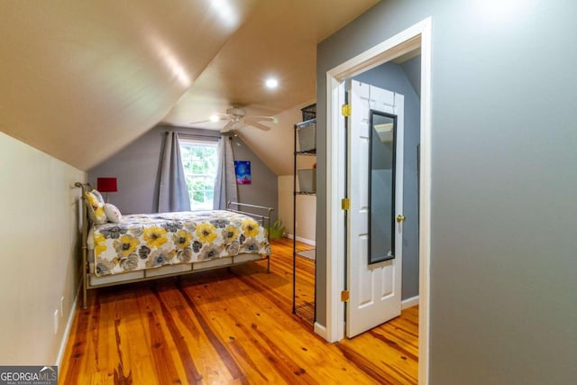 bedroom with lofted ceiling, ceiling fan, and wood-type flooring