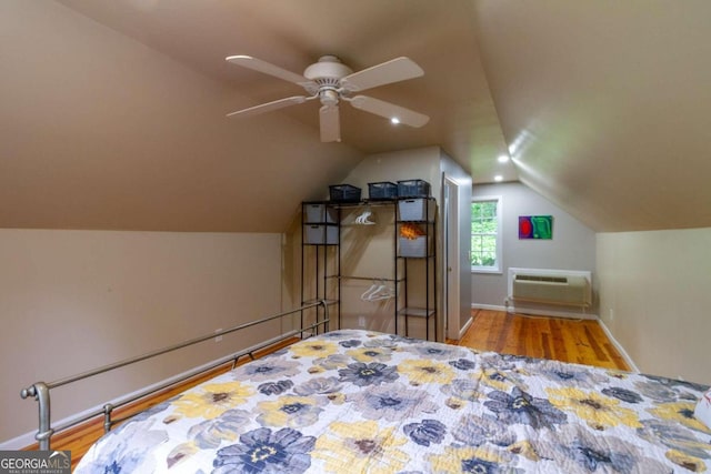 bedroom featuring an AC wall unit, ceiling fan, vaulted ceiling, and light wood-type flooring