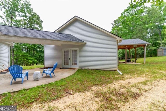 back of house with a lawn, a patio area, and french doors