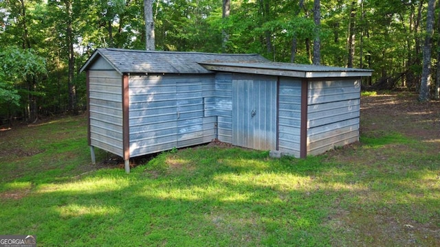 view of outbuilding with a yard