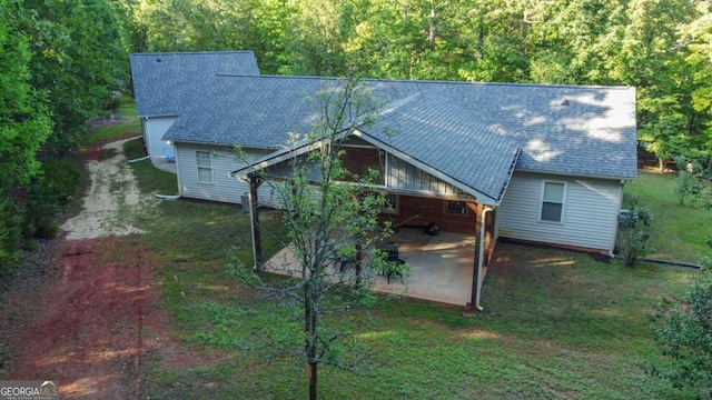 back of house with a patio area and a yard