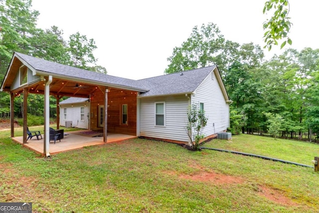 back of house featuring a lawn, ceiling fan, cooling unit, and a patio