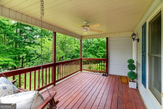 wooden deck featuring ceiling fan