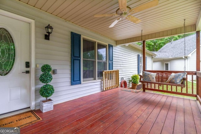 wooden deck with a porch and ceiling fan