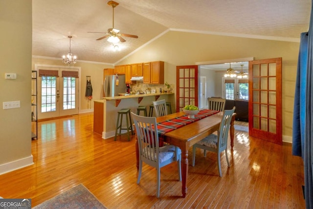 dining space with ornamental molding, light hardwood / wood-style flooring, and french doors