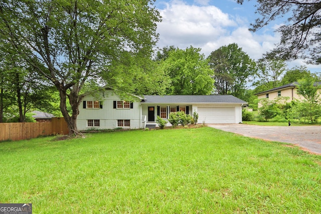 tri-level home featuring a front yard and a garage