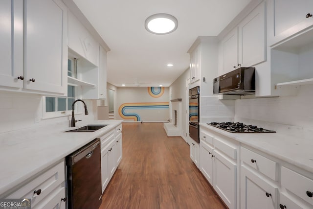 kitchen featuring dishwashing machine, gas stovetop, tasteful backsplash, and dark wood-type flooring