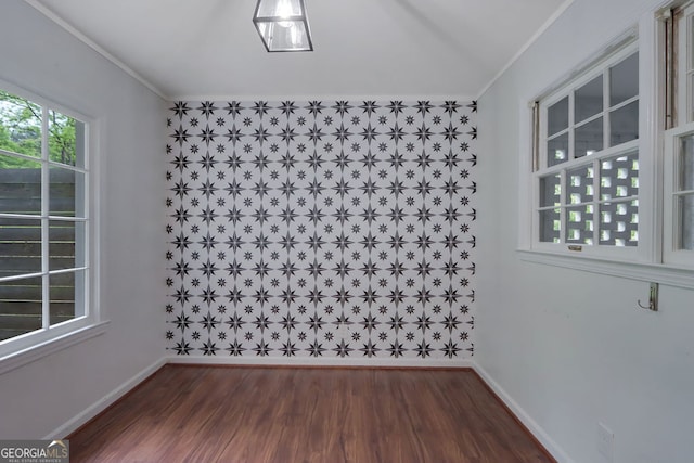 spare room with ornamental molding and hardwood / wood-style flooring