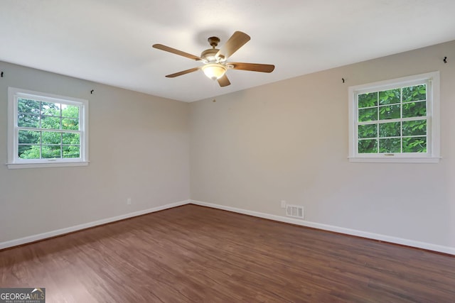 unfurnished room with dark wood-type flooring and ceiling fan