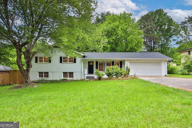 tri-level home featuring a garage and a front lawn