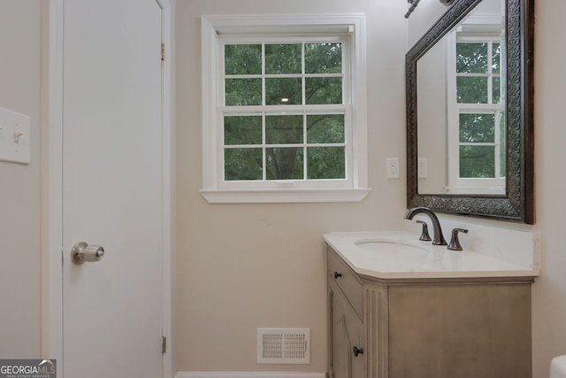 bathroom featuring plenty of natural light and vanity