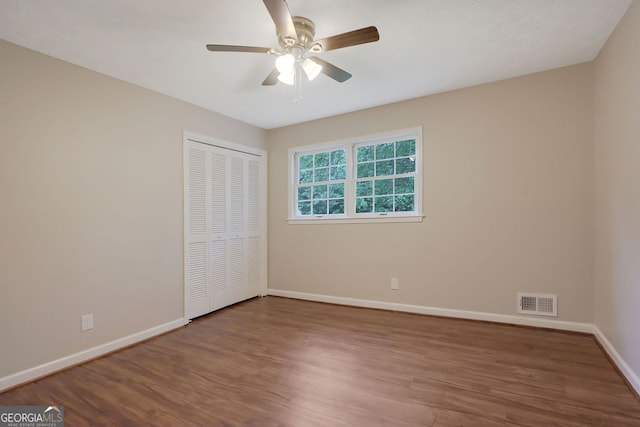 spare room with hardwood / wood-style floors and ceiling fan