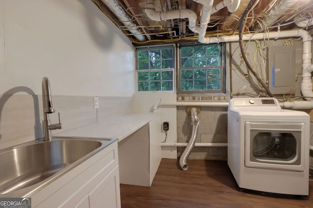 washroom featuring sink, dark wood-type flooring, and washer / clothes dryer