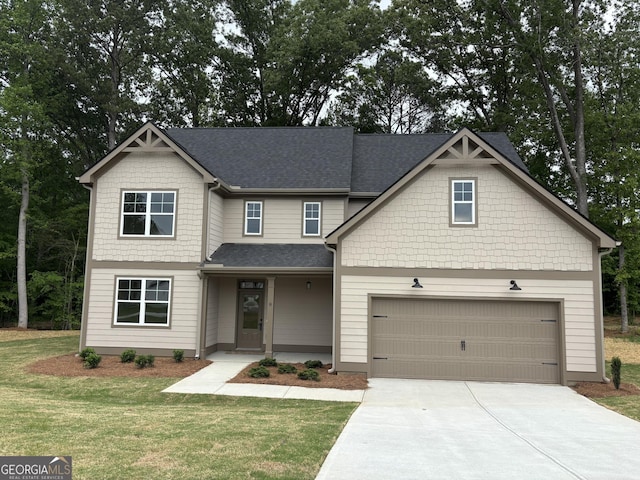 craftsman inspired home with concrete driveway, a garage, a shingled roof, and a front lawn