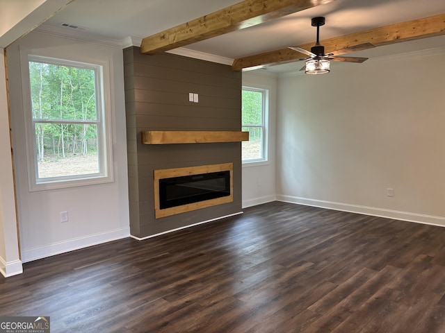 unfurnished living room featuring ceiling fan, a fireplace, dark wood finished floors, baseboards, and beamed ceiling