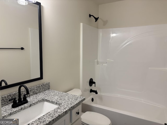 bathroom featuring vanity, bathtub / shower combination, and toilet