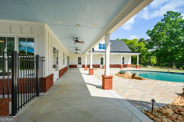 exterior space featuring ceiling fan and a fenced in pool