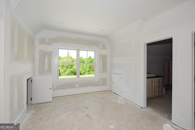 spare room with lofted ceiling