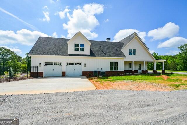 view of front of home with a garage and central AC unit