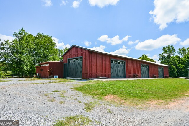 view of outdoor structure with a garage and a yard